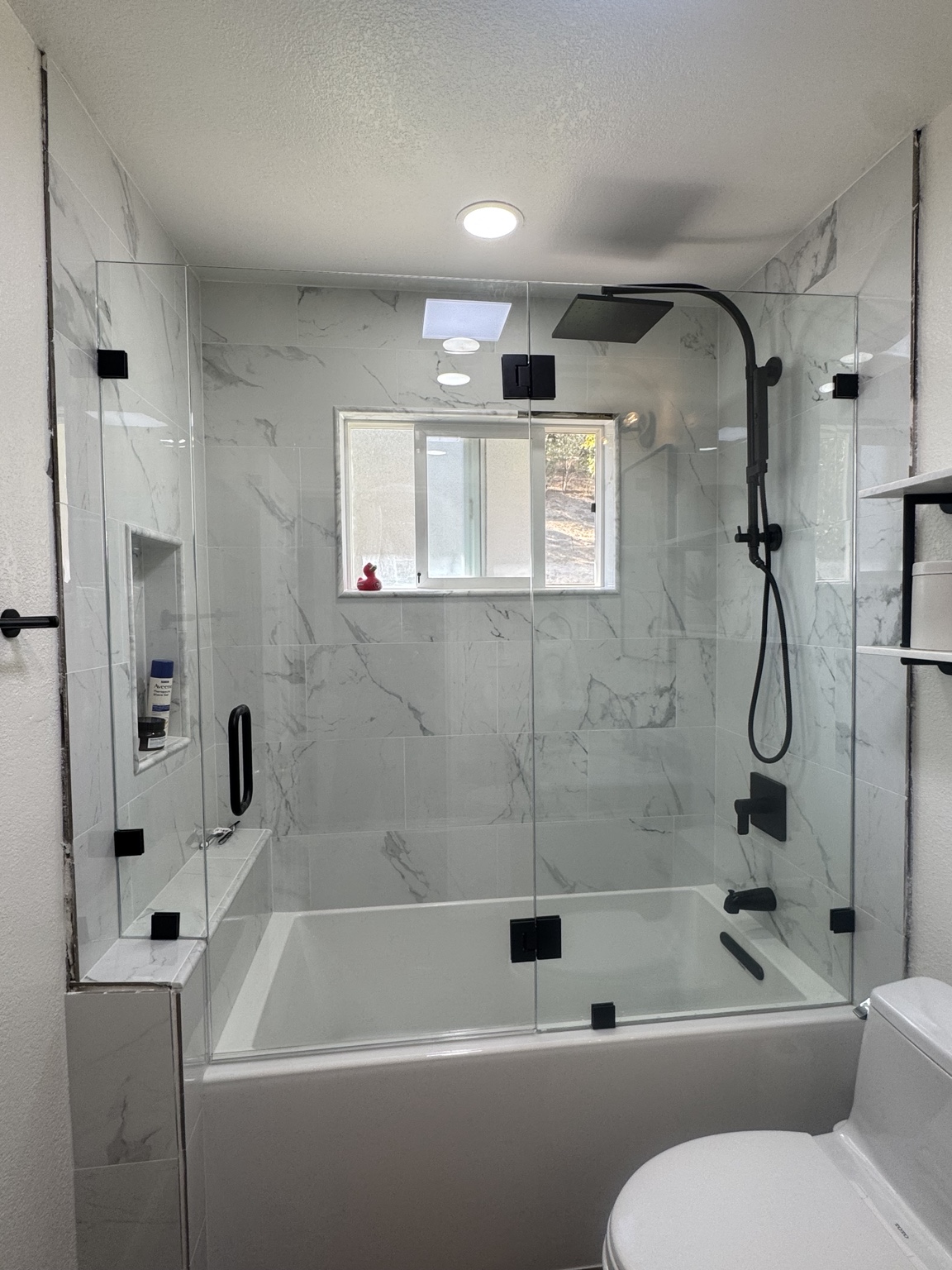 Glass doors above bathtub