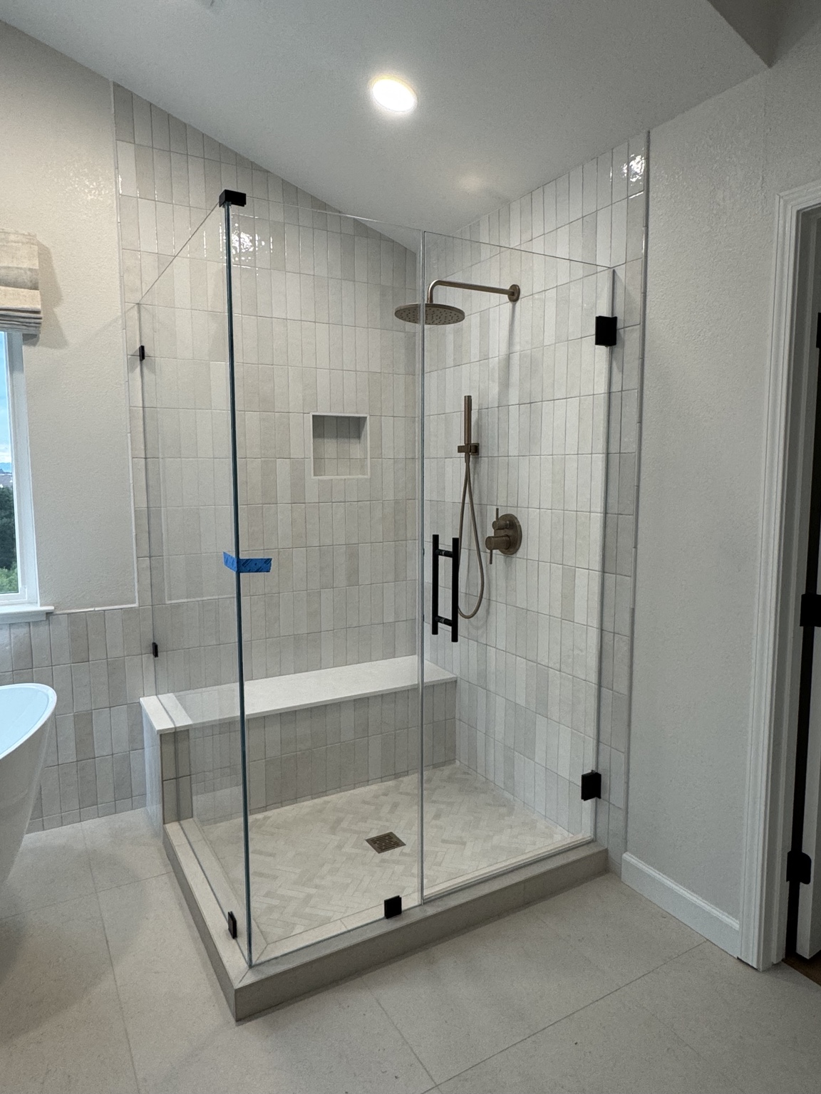 Corner shower enclosure with black hardware